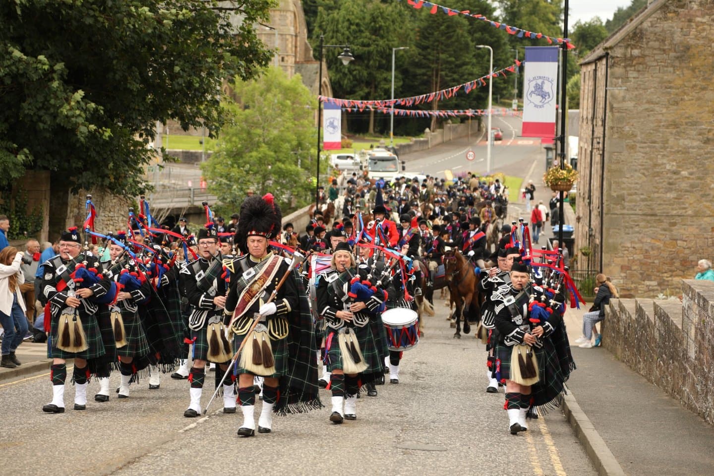 Pipe band and riders on Jedburgh’s streets during the Callant’s Festival